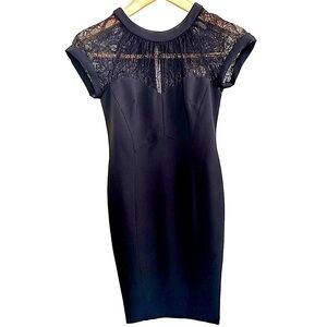 Maggy London tea length black dress. Poly and spandex for stretch fit. Lace top